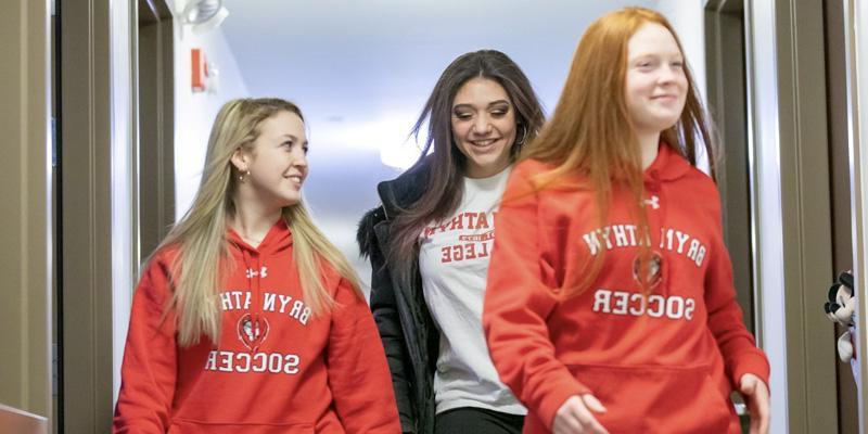 Students laugh together as they make thier way down the hallway of one of the residence life halls at Bryn Athyn College